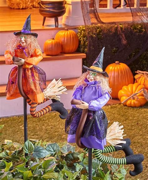 Witch figurine with stakes for halloween display